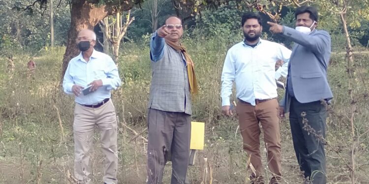Officials of the NP university A K Pandey (extreme right, CCDC) along with the CO Balumath Aftab Alam (in coat) inspecting plot of land for the degree college at Tasatbar recently