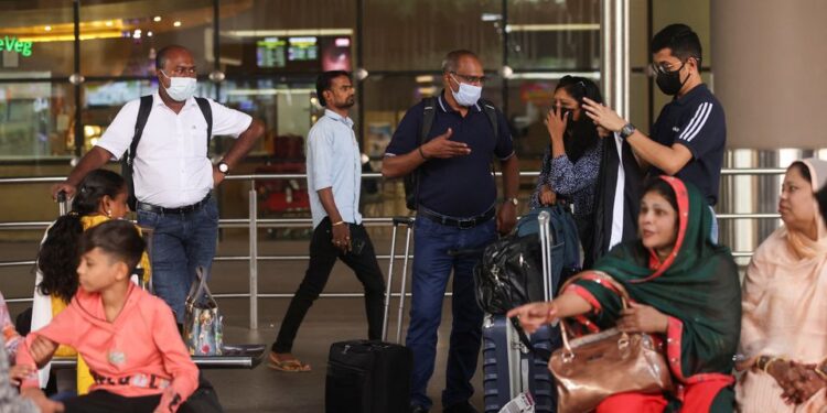 Passengers wait with their luggage at the Chhatrapati Shivaji Maharaj International Airport in Mumbai, India, December 22, 2022. REUTERS/Francis Mascarenhas/File Photo