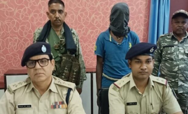 Chandil SDPO, Sanjay Kumar Singh (left) with the arrested opium smuggler standing behind during a press conference at Chandil on Tuesday