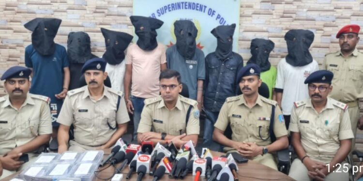Senior SP, Prabhat Kumar (at the middle) with the arrested persons standing behind at the police office during a press conference on Tuesday.