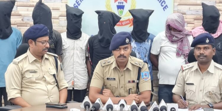 City SP, K Vijay Shankar (in the middle) with seven of the nine arrested persons standing behind at the police office during press conference on Wednesday