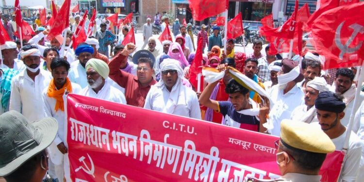 Workers affiliated with Centre of India Trade Unions (CITU) with a banner listing their demands (Photo - Amarpal Singh Verma, 101Reporters)