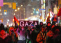 TORONTO, CANADA - JANUARY 16 : Pro-Palestinian demonstrators carrying a banner reading 'Gaza' march during a protest against Israeli attacks in Gaza since the announcement of the ceasefire, on January 16, 2025 in Toronto, Ontario. Protestors carrying Palestinian flags, gathered outside Consulate General of Israel, during a rally organized by Palestinian Youth Movement (PYM) Toronto and marched in downtown Toronto. (Photo by Mert Alper Dervis/Anadolu via Getty Images)